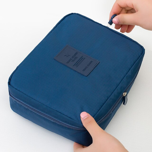 Interior view of a women's waterproof makeup travel organizer, showing compartments.