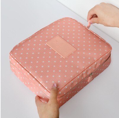 Women's waterproof makeup travel bag ready for journey, showcasing compact design.