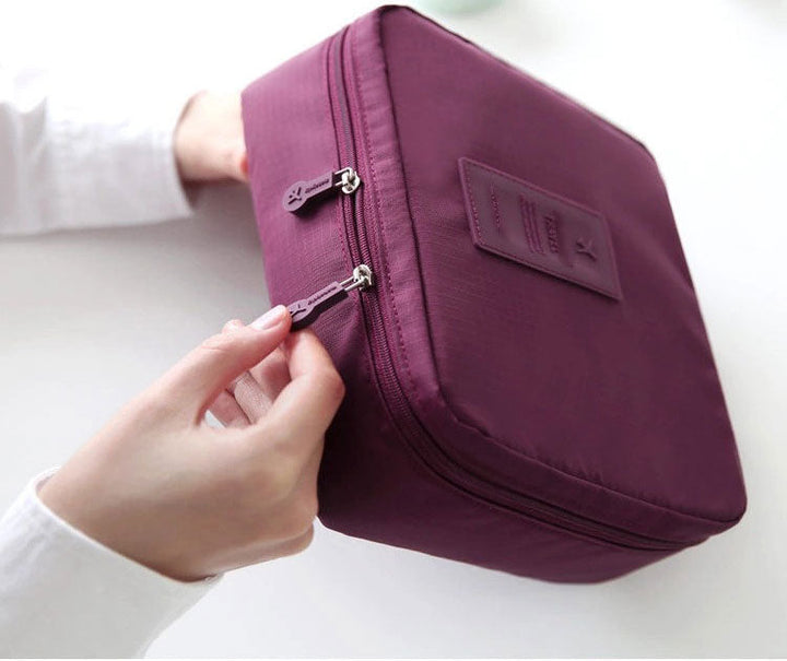 Space-saving compact women's cosmetic travel case, durable & waterproof.