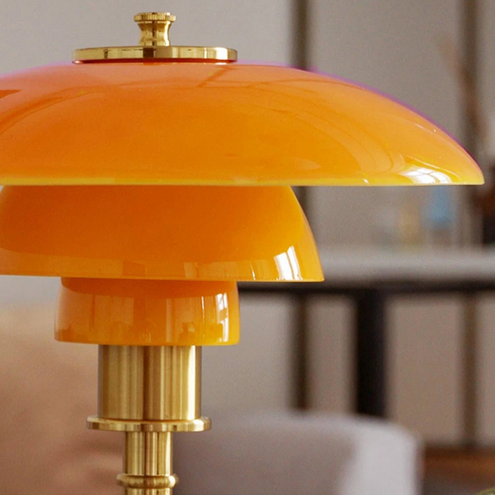 Contemporary Danish designer table lamp with warm LED light, sleek Scandinavian form, amber finish, and premium glass.