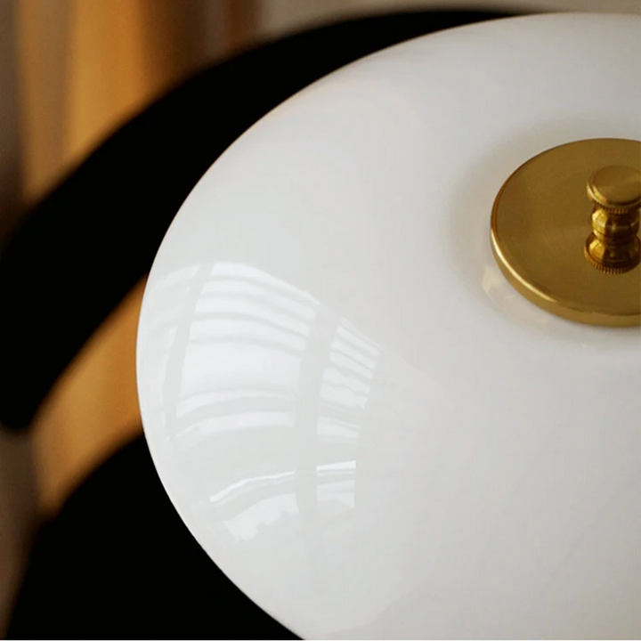 Contemporary Danish designer table lamp with warm LED light, sleek Scandinavian form, amber finish, and premium glass.