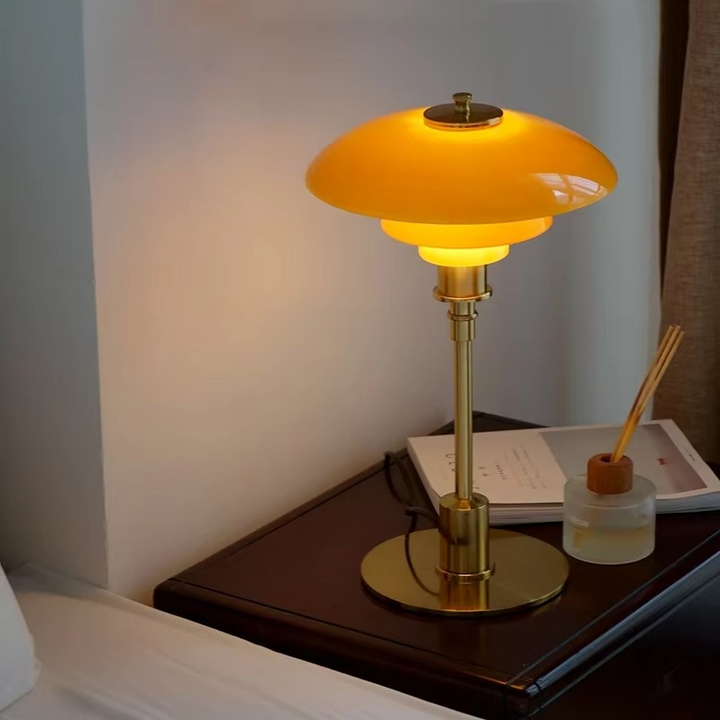 Contemporary Danish designer table lamp with warm LED light, sleek Scandinavian form, amber finish, and premium glass.