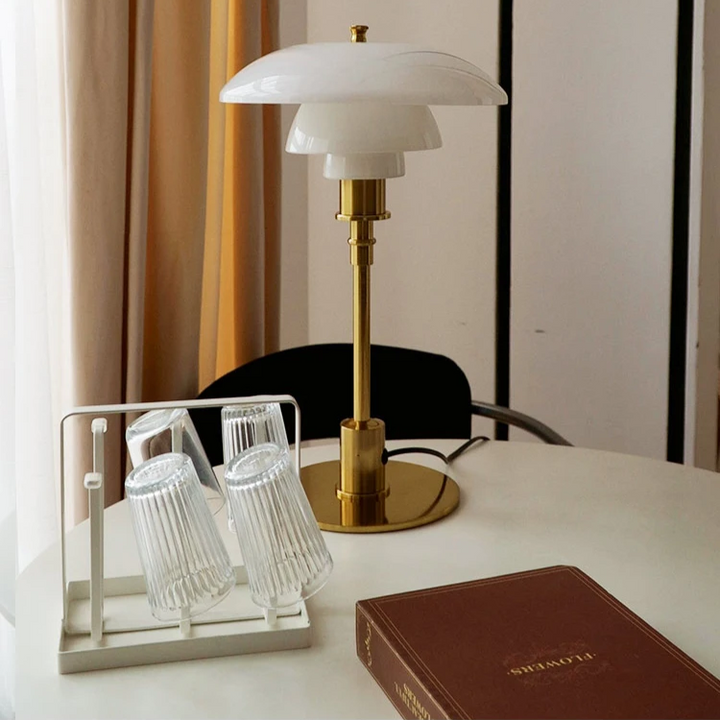 Contemporary Danish designer table lamp with warm LED light, sleek Scandinavian form, amber finish, and premium glass.