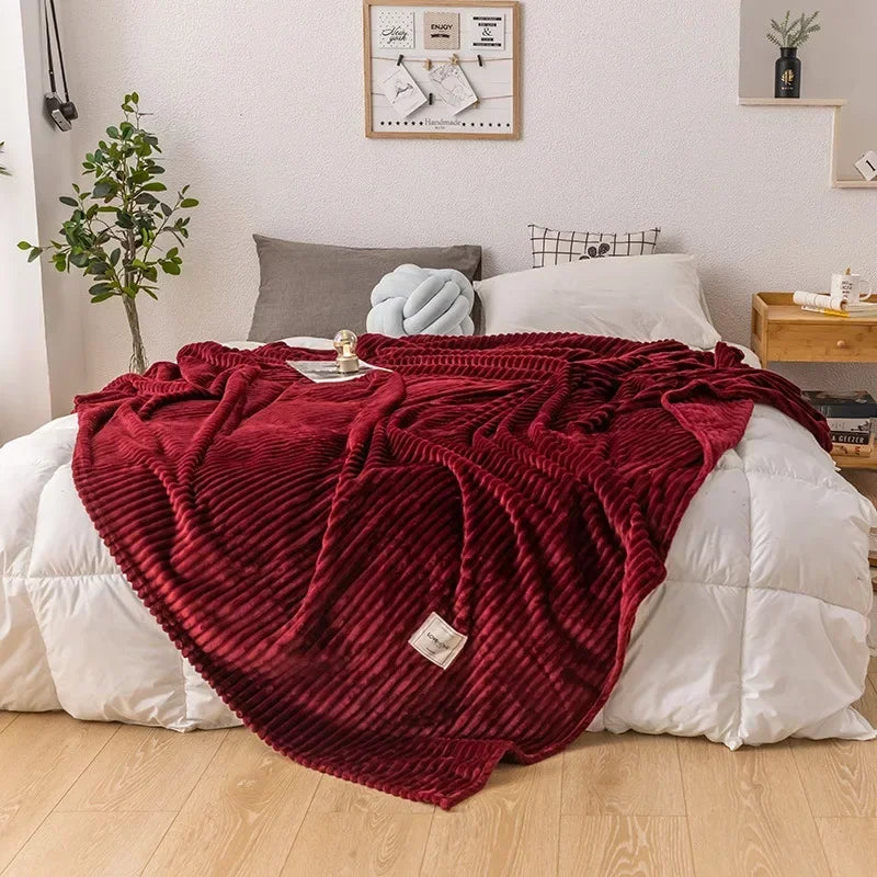 WarmHaven flannel throw blanket draped over a sofa in a living room, adding cozy comfort & autumn home decor.