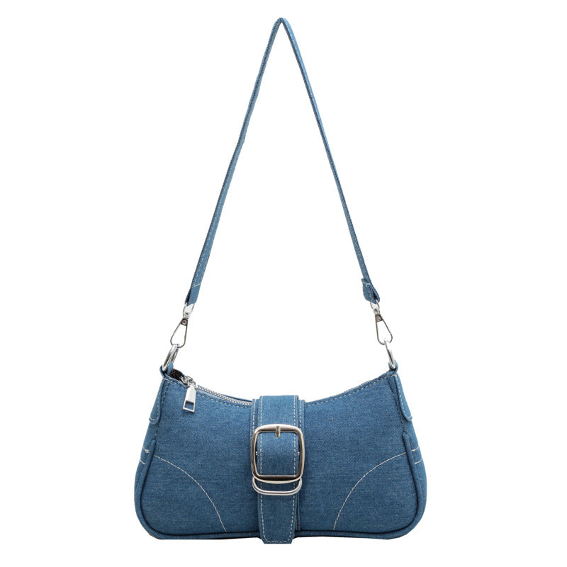 Women's versatile dark blue buckle shoulder handbag, easily converts to a crossbody bag.