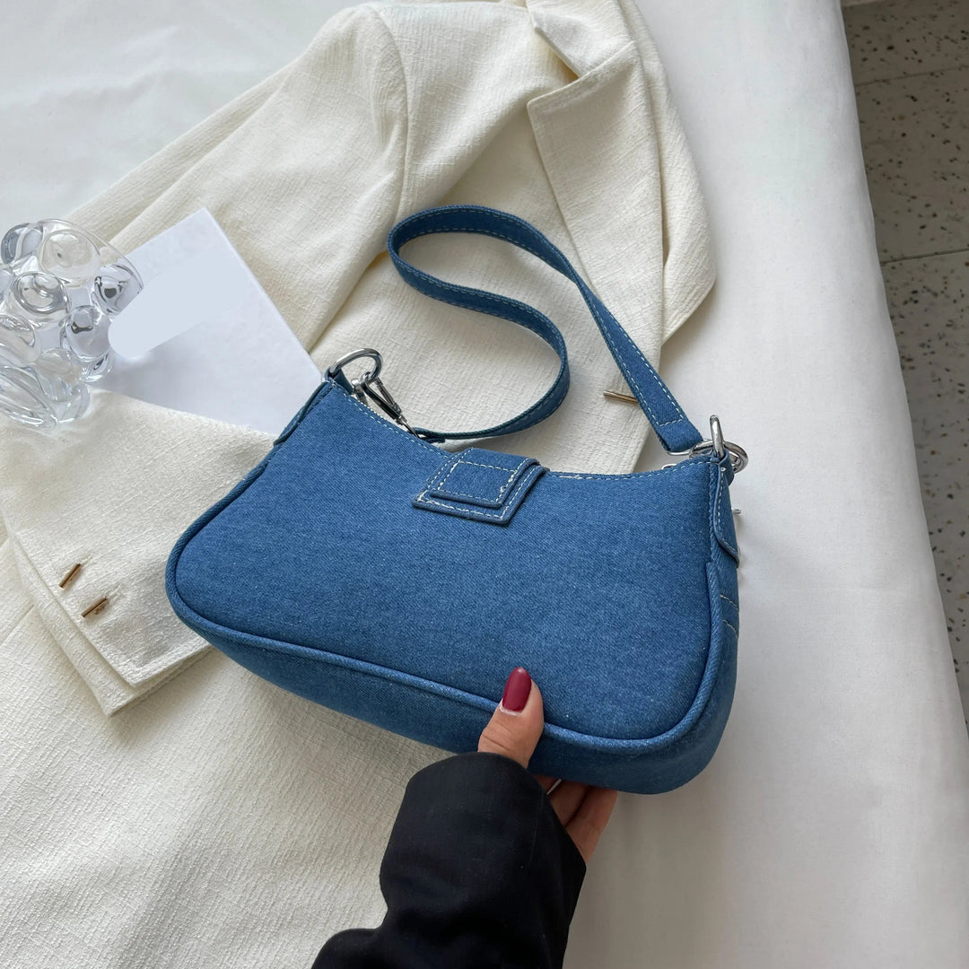 Stylish dark blue women's fashion buckle bag, a versatile shoulder and crossbody handbag.