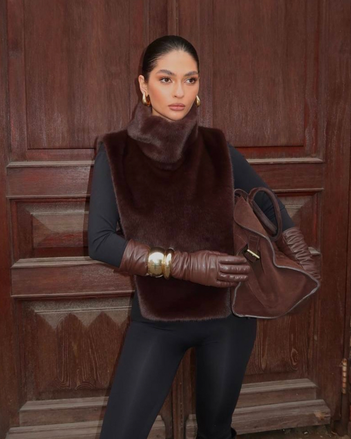 Elegant women's dark brown faux fur turtleneck vest, a must-have sleeveless item for winter fashion.