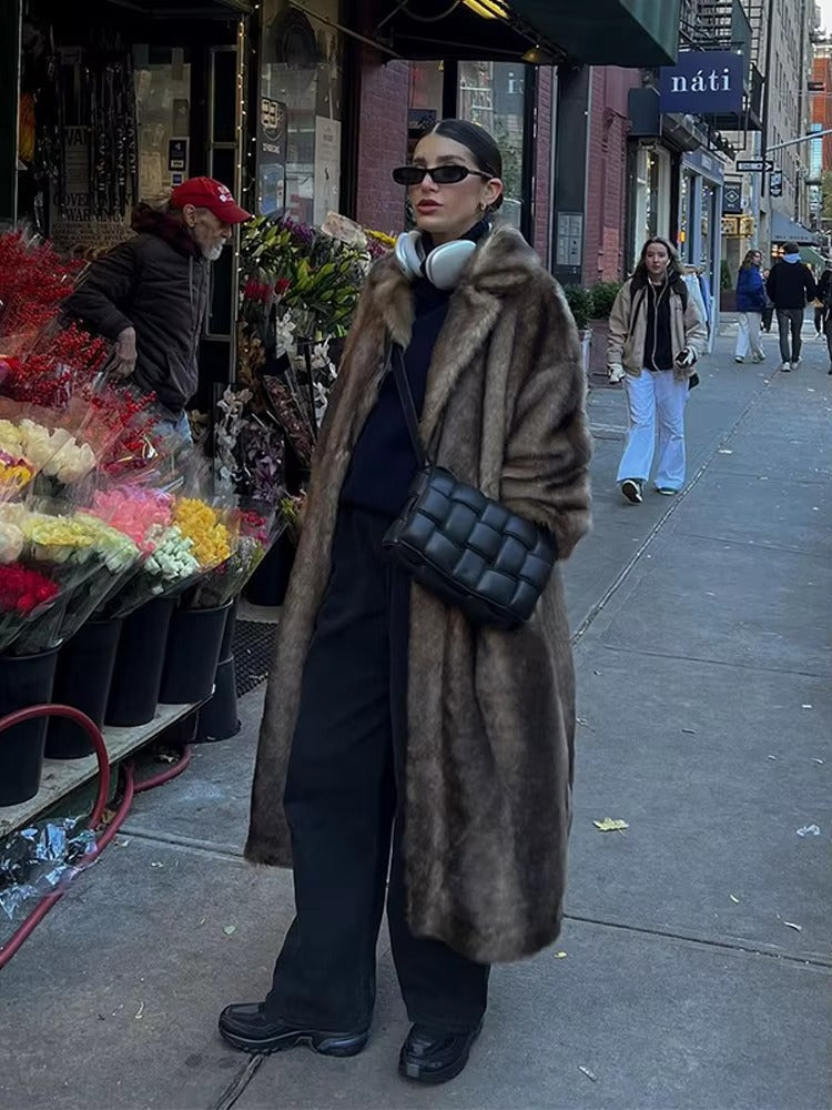 Plush dark brown women's long winter coat. Stylish oversized fit warm jacket, perfect for winter fashion.