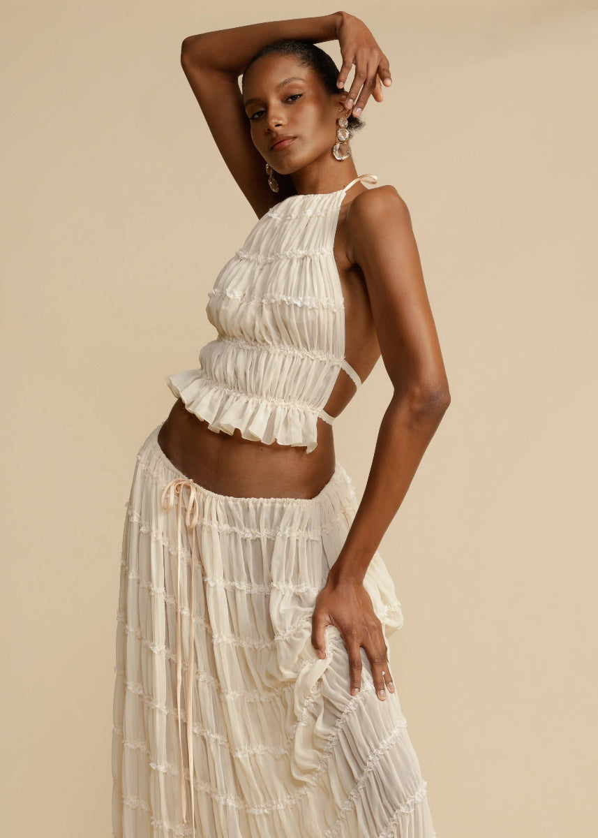 White women's two-piece summer maxi skirt set with halter top; perfect casual resort wear.