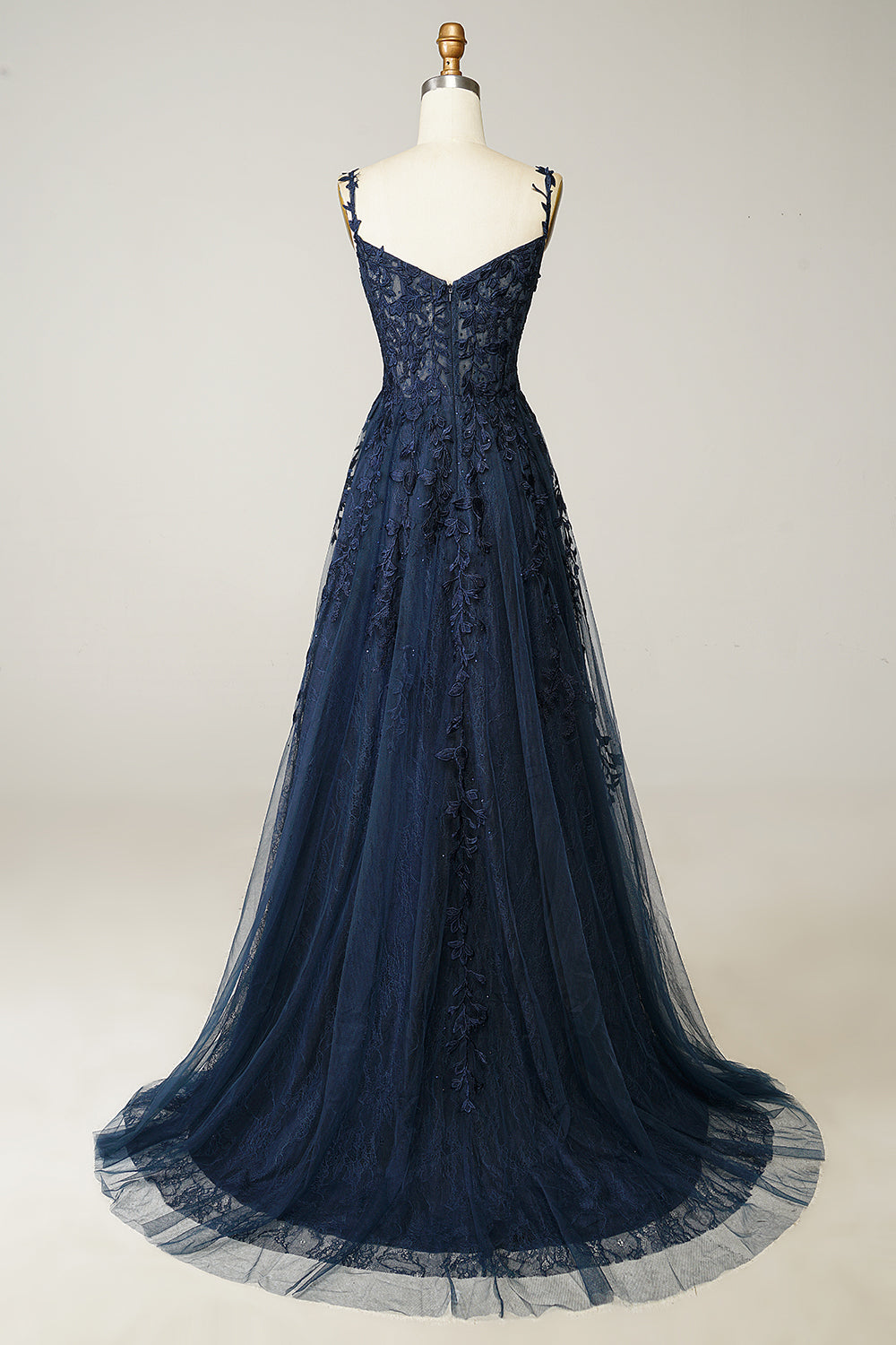 Stunning navy blue A-line ball gown featuring delicate appliques & spaghetti straps, ideal for evening wear.