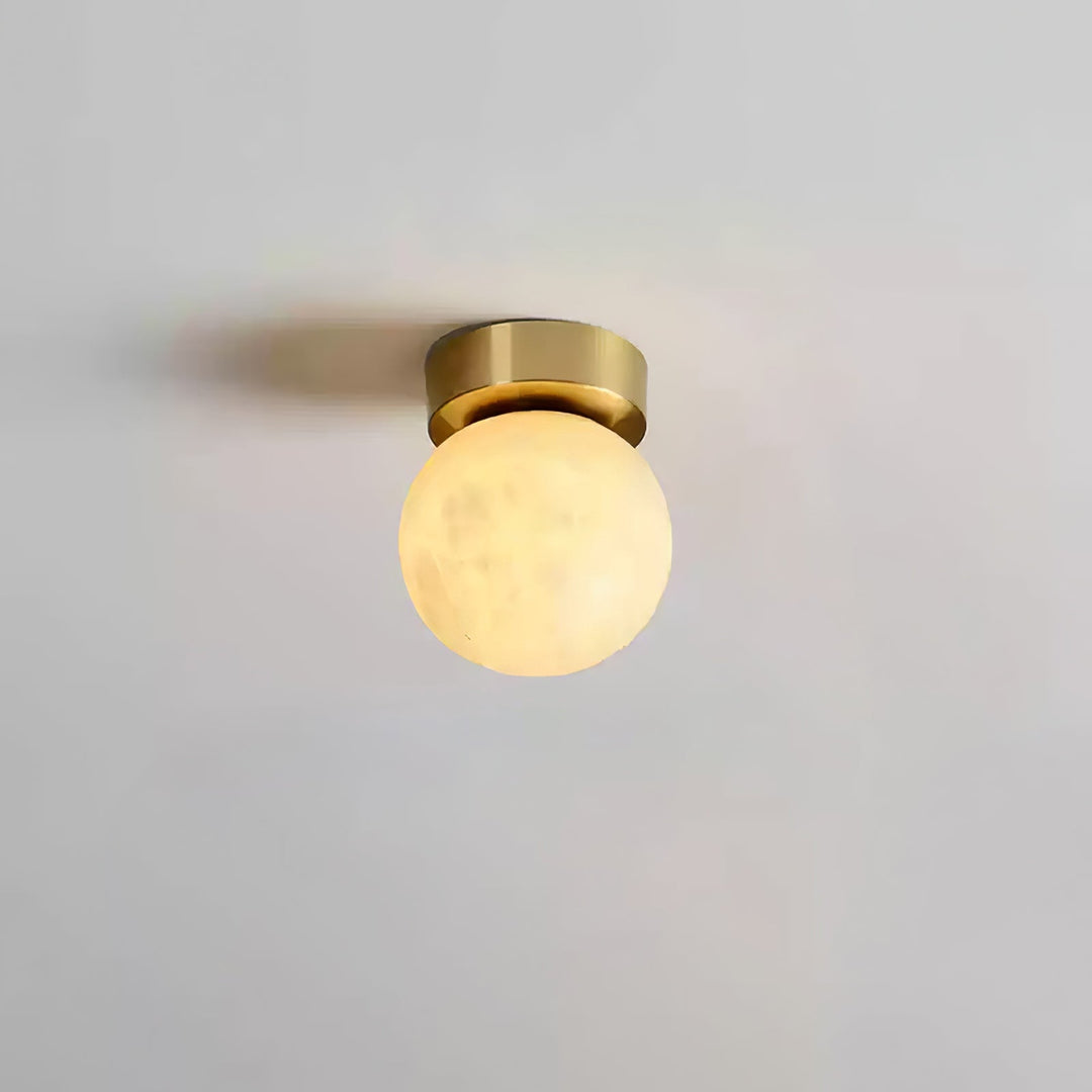 Elegant alabaster brass ceiling lamp, warm ambient light, celestial glow, sophisticated brass detailing, modern design.