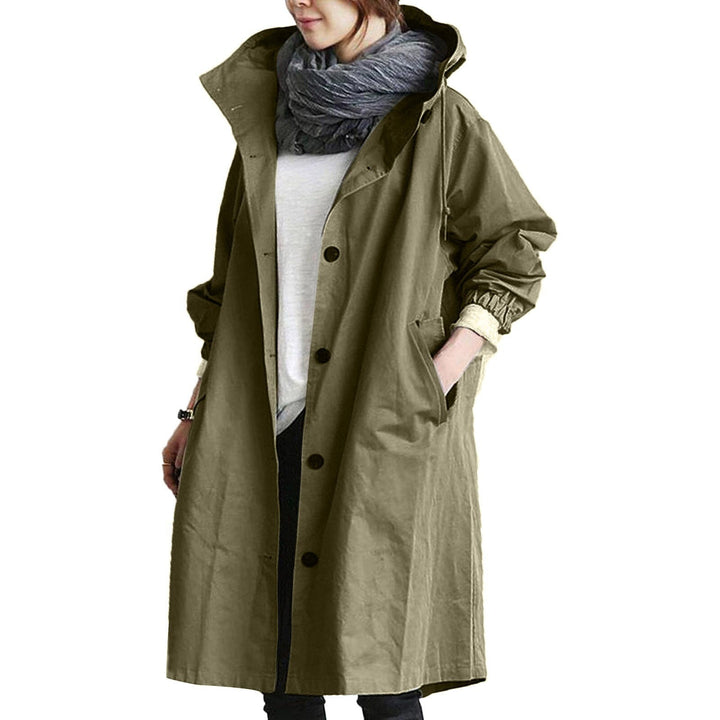 Elegant beige long waterproof raincoat for women with adjustable hood and pockets, provides style and protection in rain.