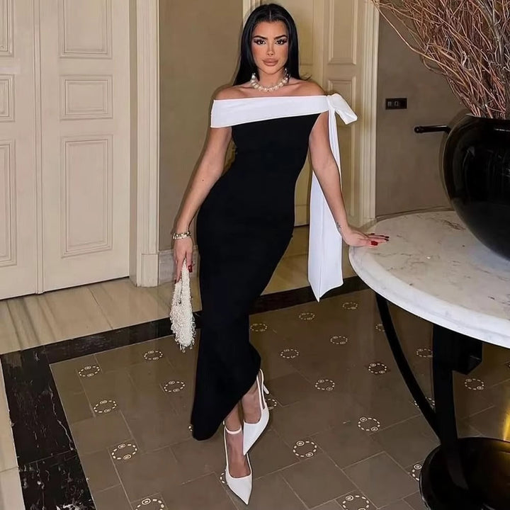 Sophisticated women's off-shoulder midi dress with a chic bow. Ideal for elegant evening wear.
