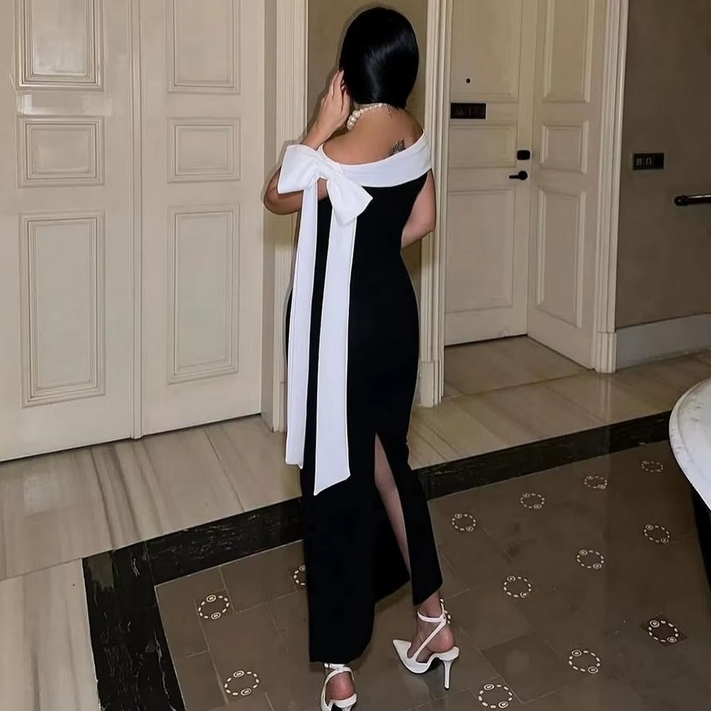 Chic women's formal midi dress; off-shoulder with bow. Elegant attire for special evening events.