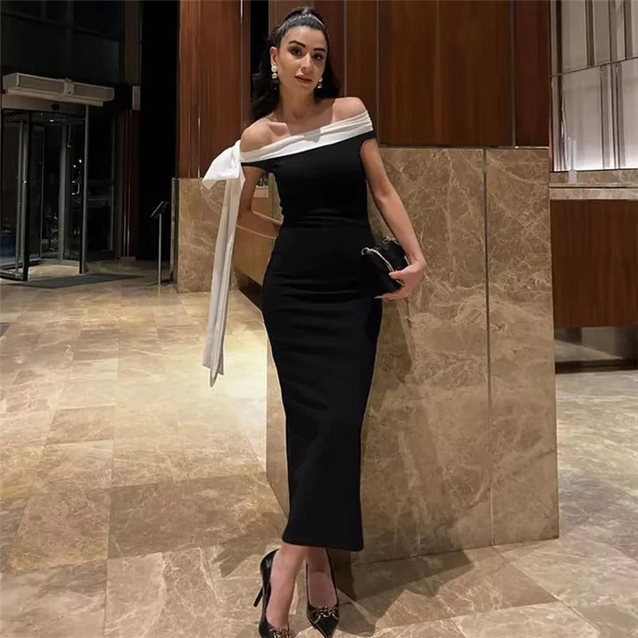 Stylish off-shoulder midi evening gown for women. Features a flattering bow detail, perfect for parties.