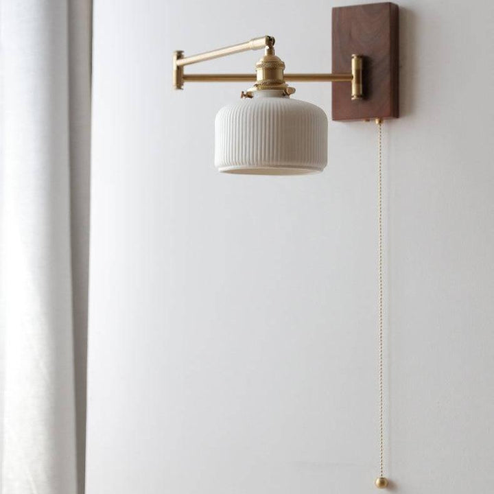 "Elegant ceramic wall lamp with wooden plate, featuring a modern design in cylinder or globe lampshade for stylish interiors.