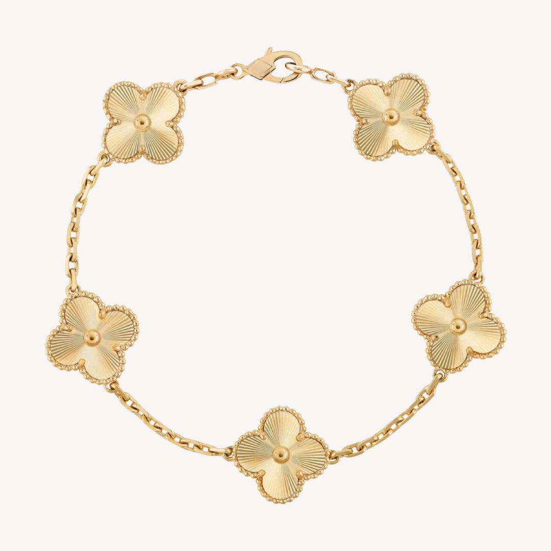 Elegant clover charm bracelet with polished black agate inlays and a gold and silver-tone chain for sophisticated style.