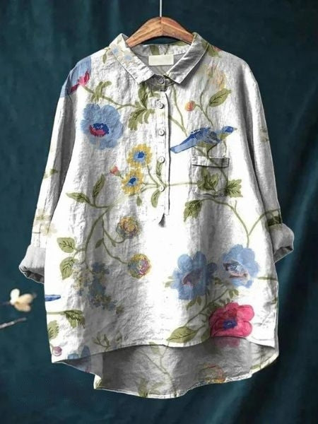 Close-up of vibrant floral print on elegant women's flowing blouse, perfect for summer.