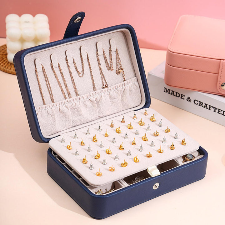 Modern flip-top jewelry organizer in sleek leather, perfect for women's vanity and travel.