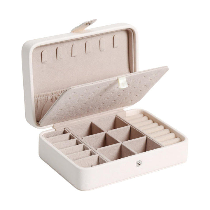 Stylish white flip-top jewelry organizer for rings, earrings, and necklaces on a vanity.