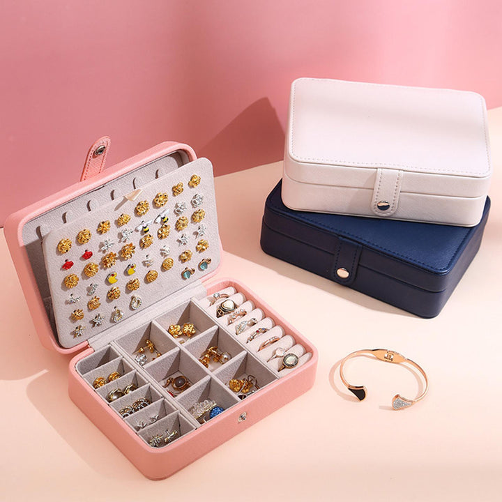Women's elegant flip-top jewelry box, premium leather organizer for earrings, rings, and chains.