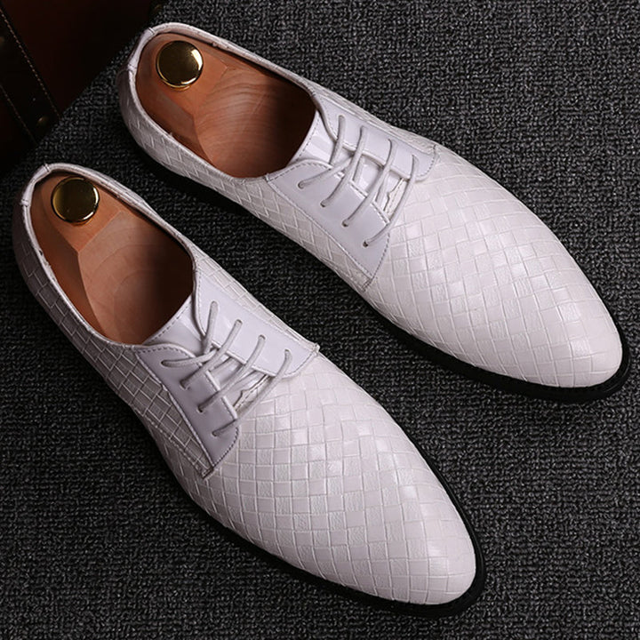 Close-up of premium men's leather Oxford shoes, showing fine lace-up detail & sleek design for professional look.