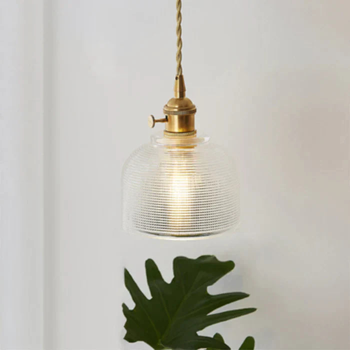 Clear glass hanging light, adding a touch of modern elegance to any kitchen.