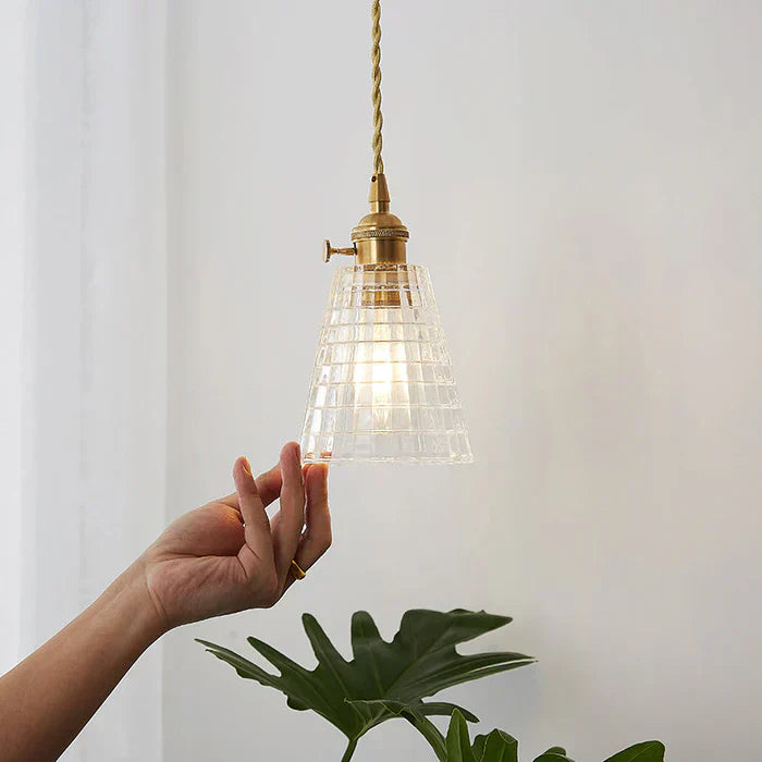 Transparent glass pendant light, modern design for dining room or kitchen lighting.