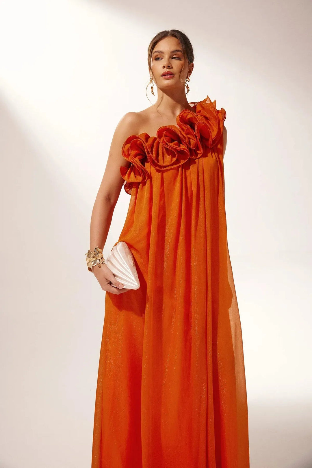 Elegant orange asymmetric one-shoulder maxi evening gown with delicate floral design, perfect for special occasions.