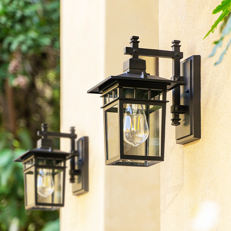 "Elegant outdoor waterproof lantern wall light with black finish and glass shade, perfect for gardens and porches."