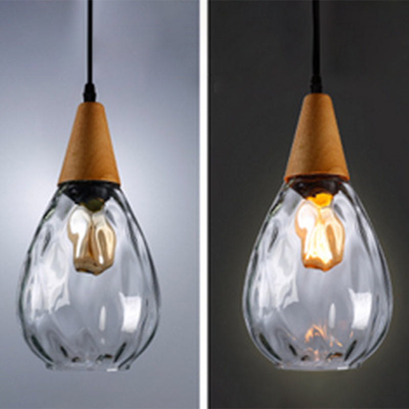 "Elegant teardrop glass pendant light with wood accents, available in clear, golden, smoky gray, perfect for any home decor."