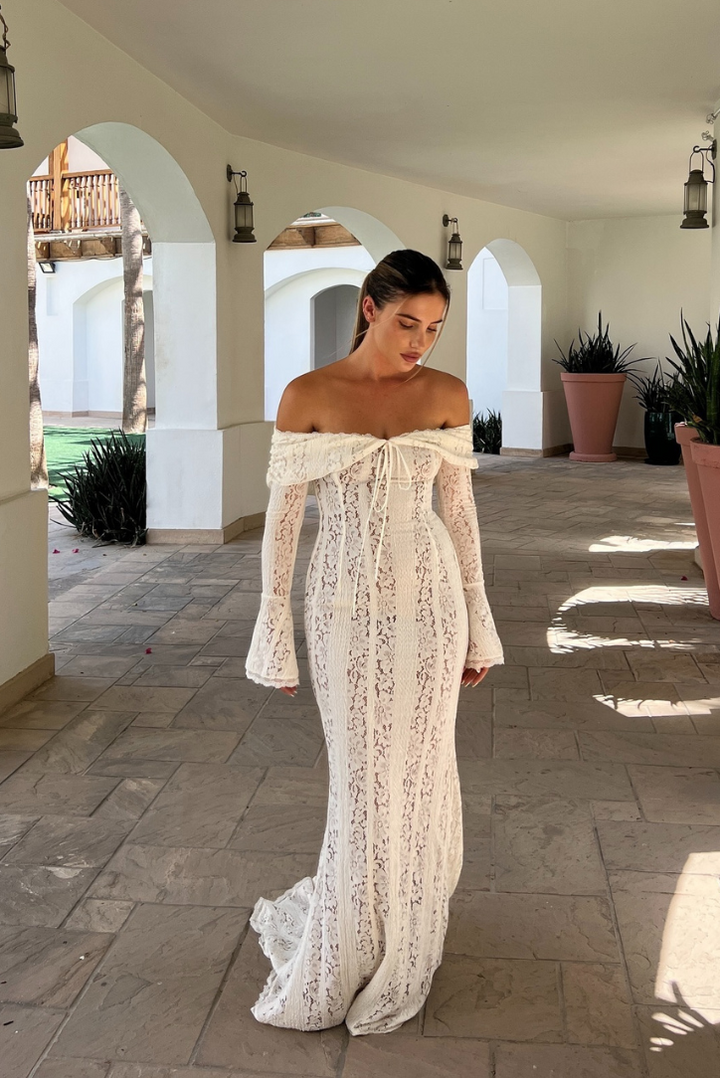 Women's elegant off-shoulder white maxi dress. Ideal formal evening gown for special occasions.