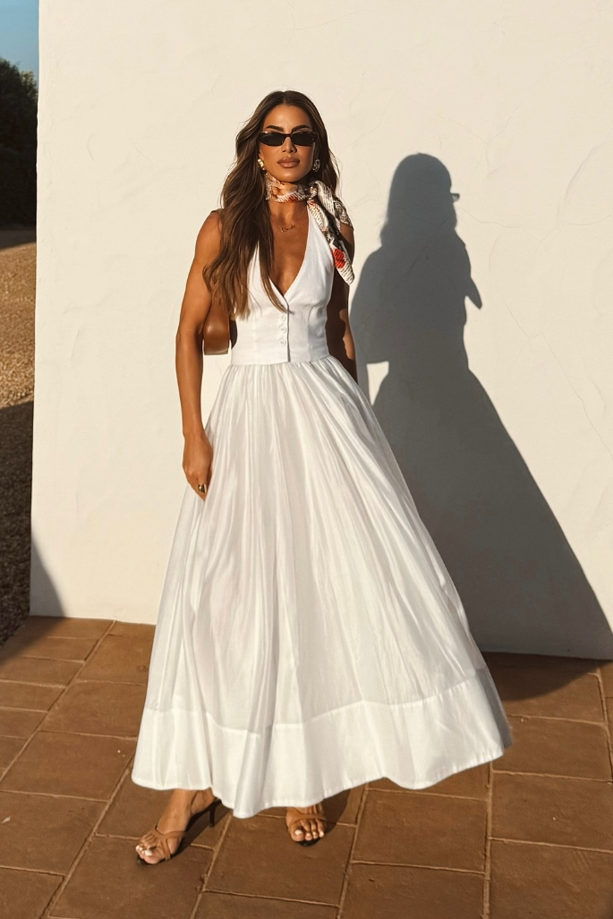 Women's elegant white summer maxi dress, sleeveless, ideal for formal occasions or beach events. Comfortable party wear.