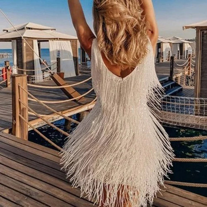 Modern women's elegant mini dress with stylish tassels. A versatile piece for parties & casual chic events.