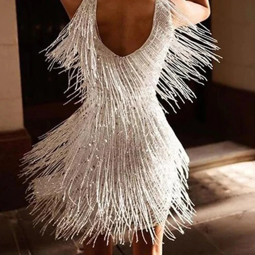 Party-ready women's white mini dress adorned with elegant tassels. Ideal for holiday celebrations.