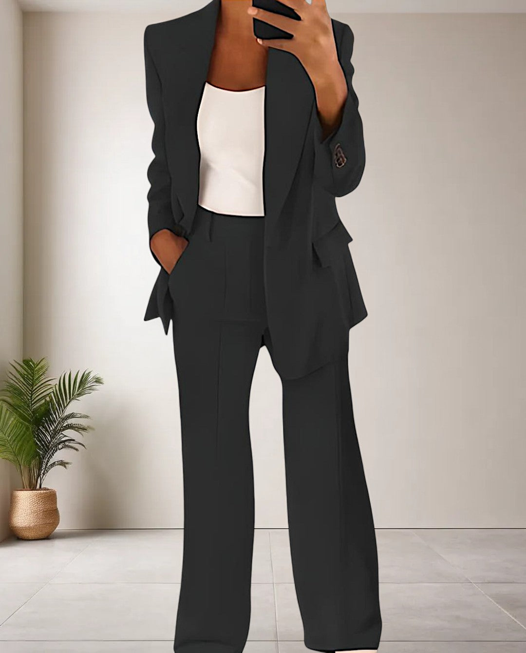 Modern women's chic 2-piece pantsuit. Versatile blazer and trousers set for casual or professional style.