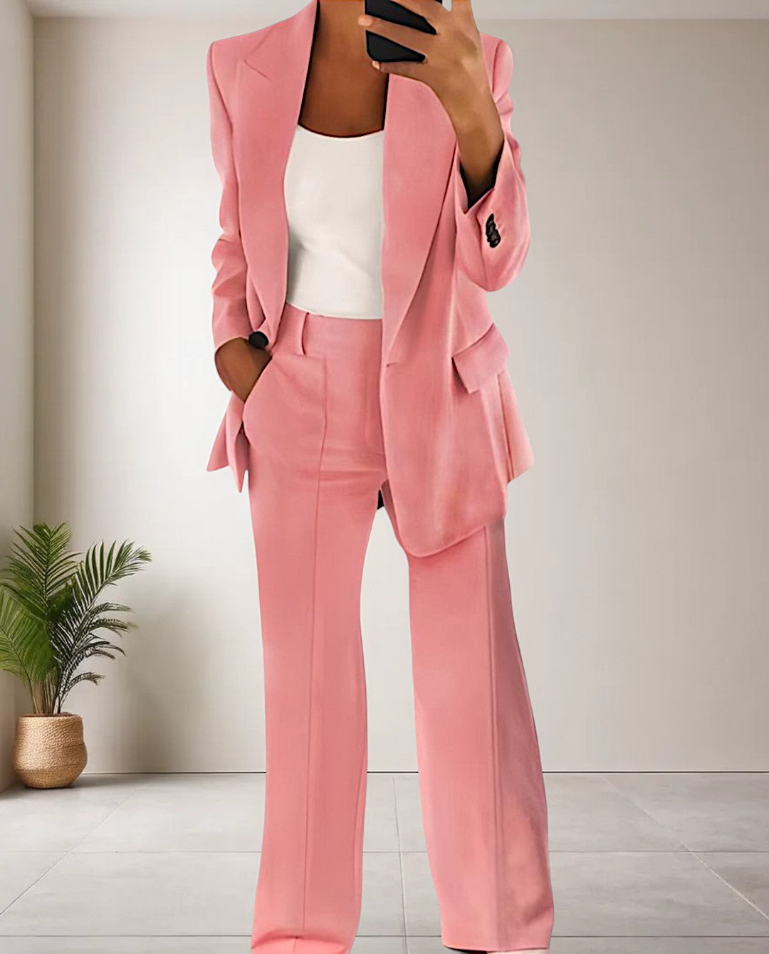 Trendy women's professional pantsuit set. Two-piece blazer and trousers for business wear and elegant office fashion.