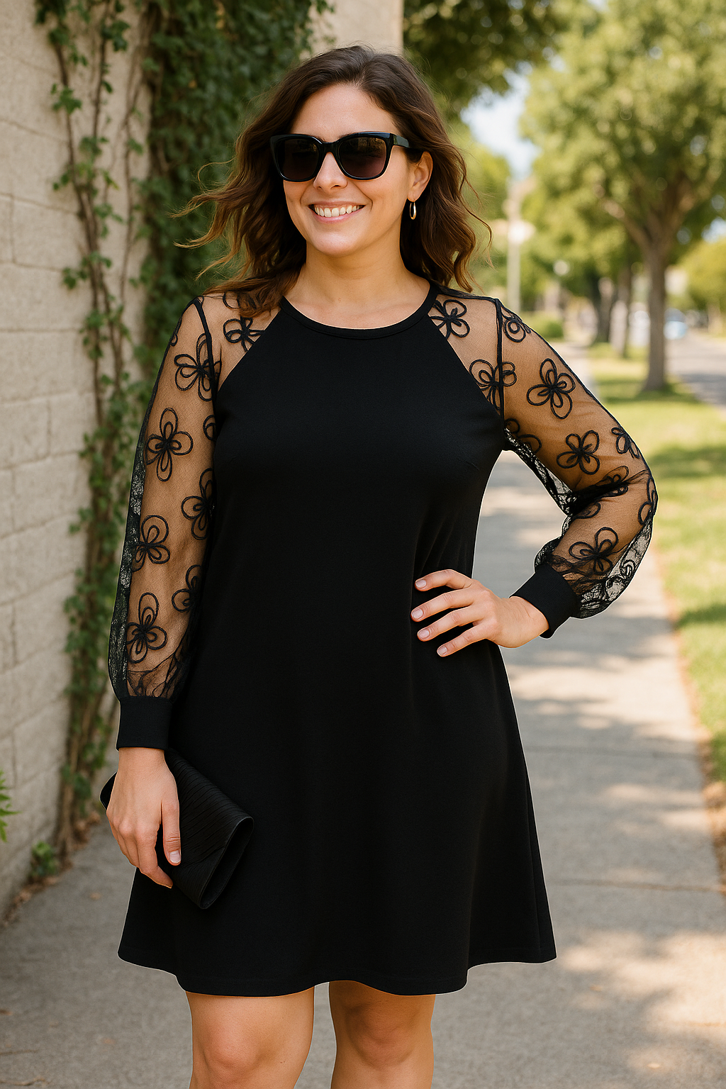 Close-up of sheer embroidered long sleeves on an elegant women's A-line formal evening gown.