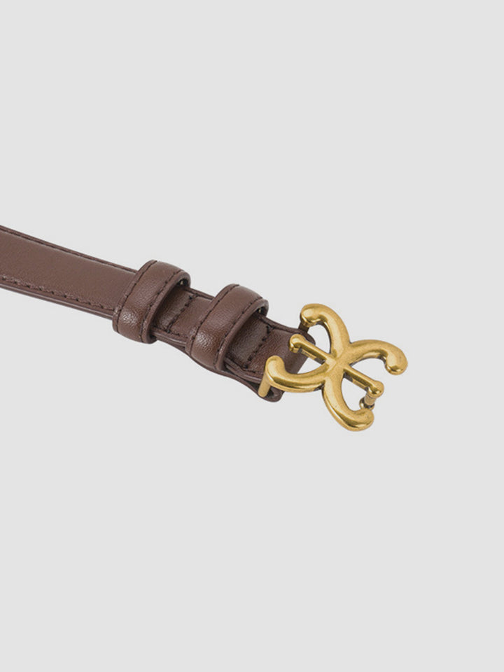 Chic brown leather waist belt for women, an essential fashion accessory with a unique sculpted buckle detail.