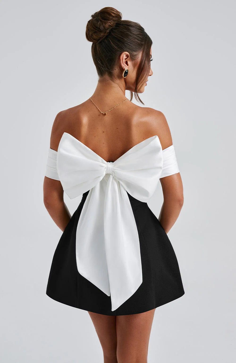 Chic women's black mini cocktail dress featuring a trendy bubble skirt for evening parties.