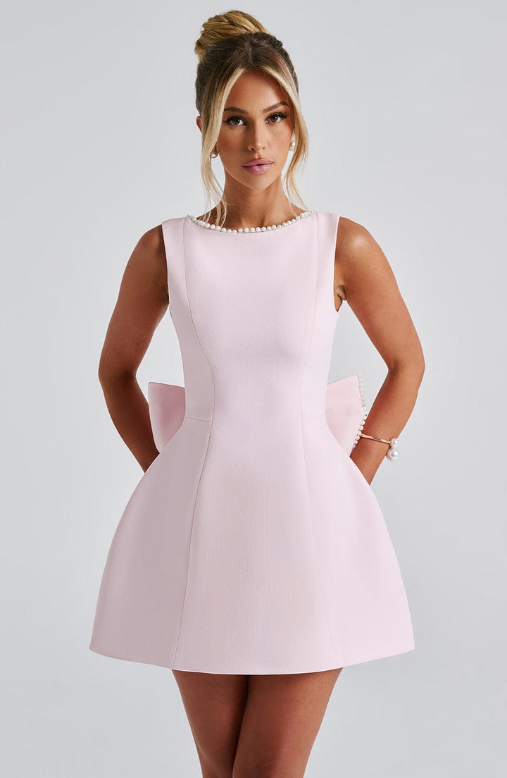 Women's elegant cocktail party mini dress with a cute bow back and subtle pearl trim. Perfect for special events.