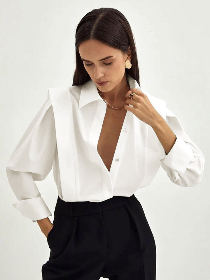 Crisp white long-sleeve women's button-down blouse, a classic & versatile square shirt for chic styling.