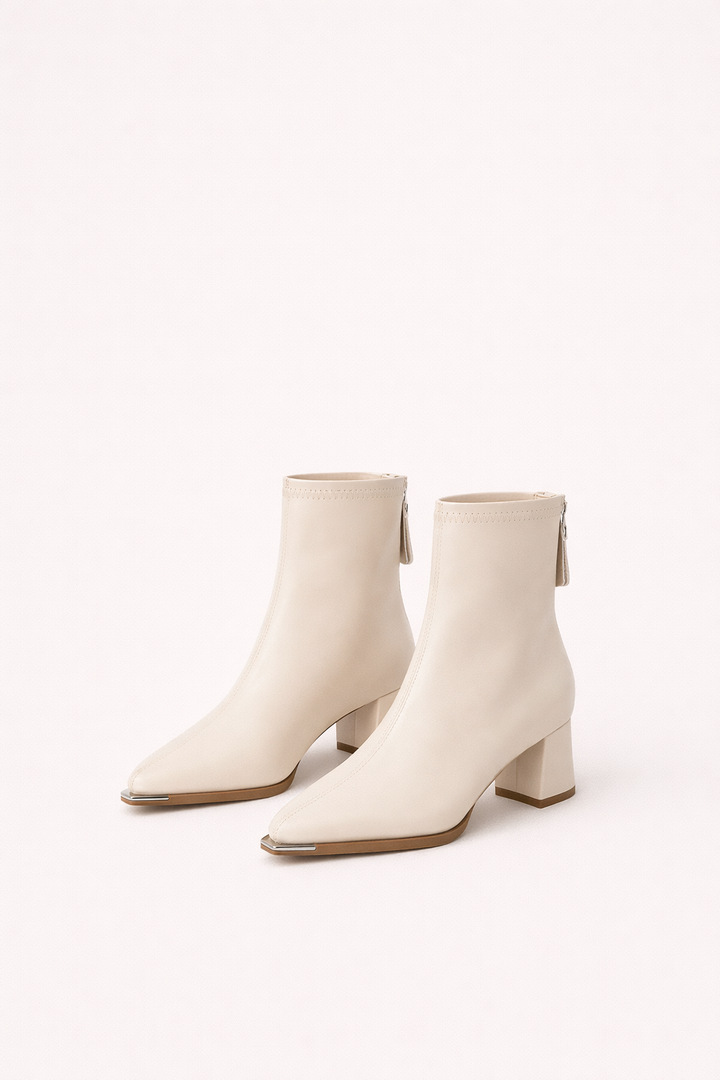 Elegant women's cream ankle boots with a comfortable block heel. Versatile and minimalist fashion.