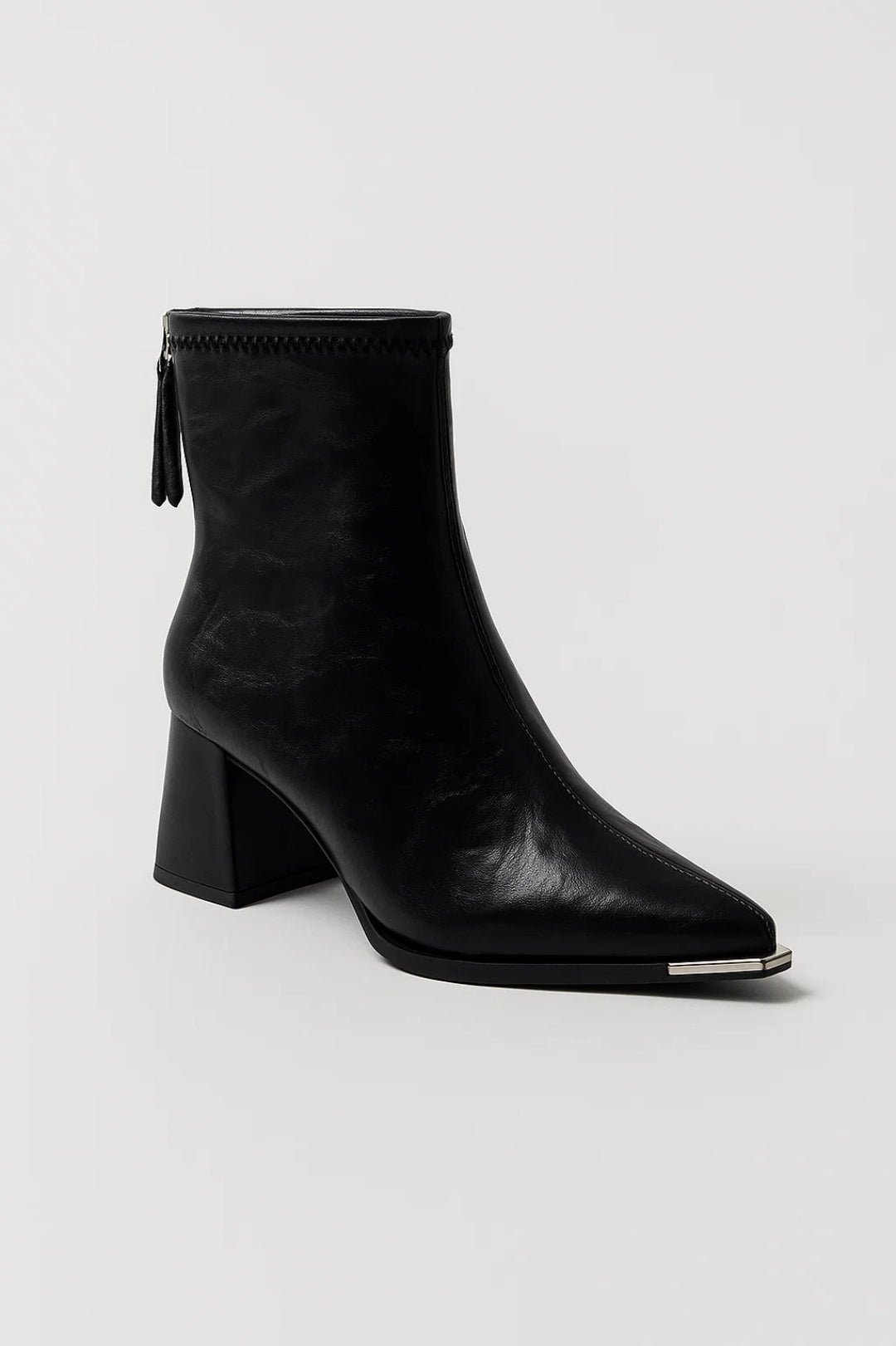 Luxe women's cream ankle boots. Features a pointed toe and sturdy block heel for an elegant, comfortable look.