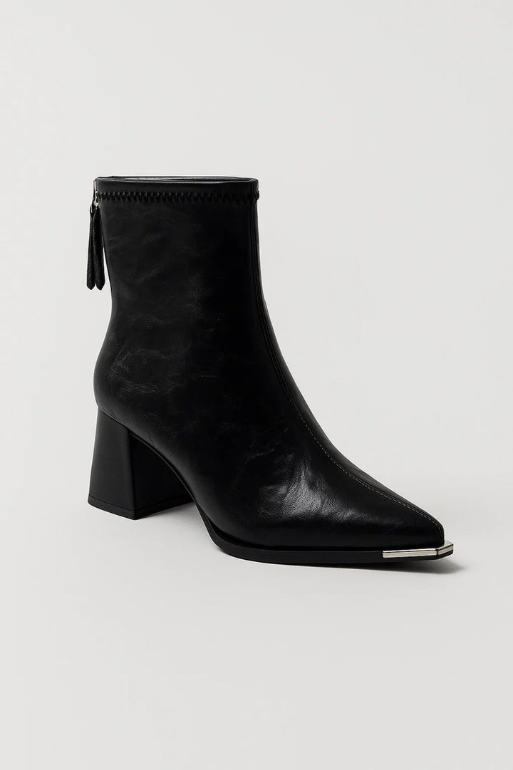 Luxe women's cream ankle boots. Features a pointed toe and sturdy block heel for an elegant, comfortable look.