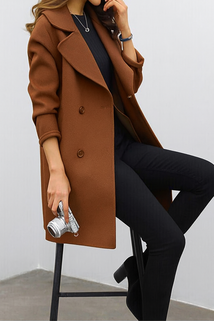 Classic women's long trench coat with a sharp lapel and double-breasted front. Perfect for fashion.
