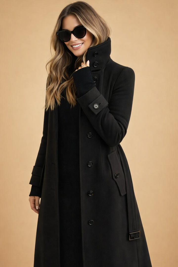 Structured women's long double-breasted winter jacket with a sophisticated high-neck collar design.