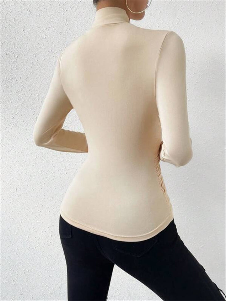 Chic women's long sleeve top with flattering draped crossover design. A solid color wardrobe essential.