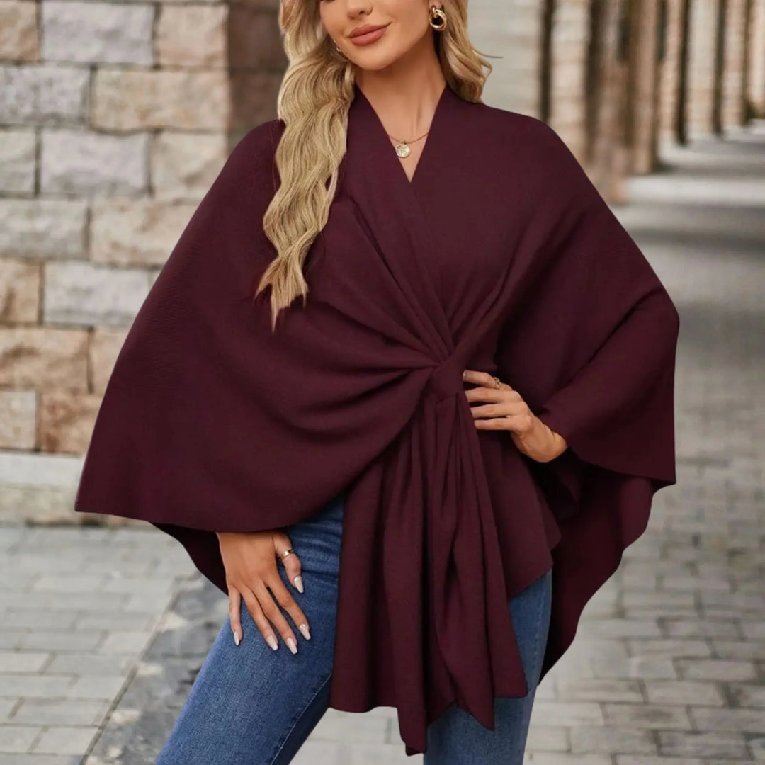 Stylish women's fashion poncho, draped with a flowing design for elegant, comfortable, versatile outerwear.