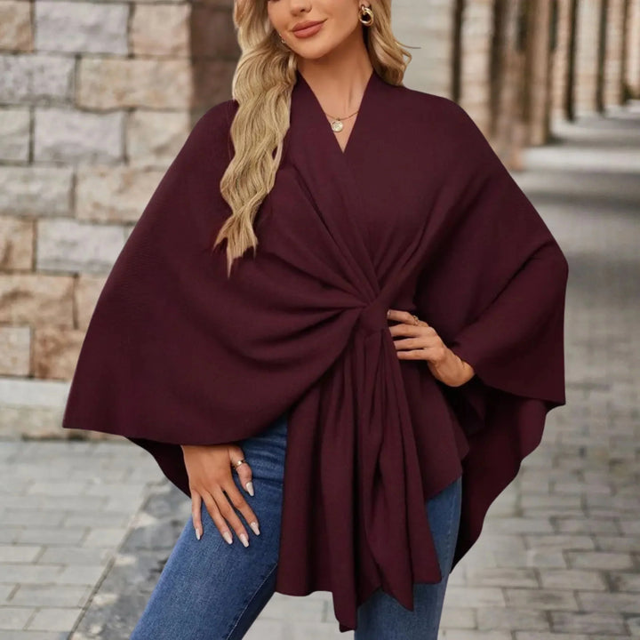 Stylish women's fashion poncho, draped with a flowing design for elegant, comfortable, versatile outerwear.